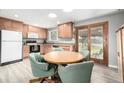 Bright eat-in kitchen with stainless steel appliances, wooden cabinets and sliding glass doors to yard at 356 Aquarius Ct, Littleton, CO 80124