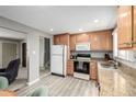 Well-lit kitchen features granite countertops, light wood cabinets and stainless steel appliances at 356 Aquarius Ct, Littleton, CO 80124
