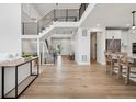 Open-concept floor plan with wood floors, a modern staircase, and white walls at 6851 Copper Sky Cir, Castle Pines, CO 80108