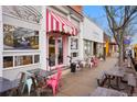 Charming storefront featuring a pink striped awning, outdoor seating, and large windows showcasing the interior at 657 Nightsky St, Erie, CO 80516