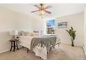 Cozy bedroom with a ceiling fan, a plush bed, and a bright window view at 2231 S Vaughn Way # 317 B, Aurora, CO 80014