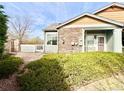 Cozy outdoor patio, perfect for relaxing, with a stone wall and sliding glass door access at 12830 Jasmine St # A, Thornton, CO 80602