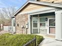 Charming front entrance featuring stone accents, landscaped garden, and a welcoming entryway at 12830 Jasmine St # A, Thornton, CO 80602