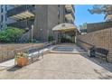 The Park Lane Condominium entrance with covered walkway and manicured landscaping at 460 S Marion Pkwy # 102, Denver, CO 80209