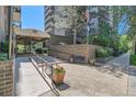 The Park Lane Condominium entrance with flag pole and sitting benches at 460 S Marion Pkwy # 102, Denver, CO 80209