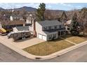 Two-story home with spacious driveway, RV parking, and mountain views in the background at 4391 S Tabor Ct, Morrison, CO 80465