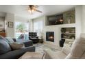 Bright living room featuring a fireplace, comfortable seating, and abundant natural light at 15800 E 121St Ave # 4G, Brighton, CO 80603