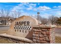 An artistic sign of Jasper Street with beautiful landscaping and stone borders at 15800 E 121St Ave # 4G, Brighton, CO 80603