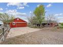 Spacious property includes a large garage, home and garden space, set against a backdrop of lush greenery at 3559 Meadow Ln, Brighton, CO 80603