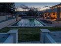 Backyard pool with fountains surrounded by a patio, grass area, and privacy walls for a relaxing outdoor space at 15902 W 64Th Ave, Arvada, CO 80007