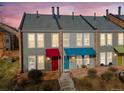 Charming townhomes featuring brick accents, colorful awnings, and well-maintained landscaping at 1150 Inca St # 39, Denver, CO 80204