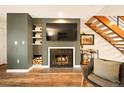 Cozy living room featuring a fireplace, built-in shelves, and wood flooring at 1150 Inca St # 39, Denver, CO 80204