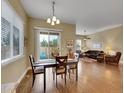 Inviting dining area with hardwood floors, a sliding glass door to the backyard, and seamless access to the living room at 668 E Dry Creek Cir, Littleton, CO 80122