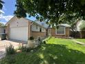 Beautiful exterior view showcasing well-manicured lawn and landscaping at 45 Pierce St, Lakewood, CO 80226