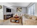 Comfortable living room featuring a fireplace, TV, large sectional sofa, and stylish decor at 45 Pierce St, Lakewood, CO 80226