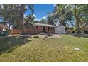Charming brick home with an attached garage, mature trees, and a well-maintained front yard at 334 S Revere St, Aurora, CO 80012