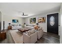 Bright living room featuring hardwood floors, comfortable seating, and stylish decor at 334 S Revere St, Aurora, CO 80012