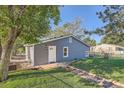 Exterior of a freshly painted single-story home with a well-maintained lawn and walkway at 1764 W Atlantic Pl, Denver, CO 80223
