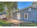 Newly renovated home with a charming entryway, modern lighting, and manicured front lawn at 1764 W Atlantic Pl, Denver, CO 80223