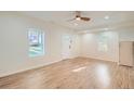 Bright living room featuring updated flooring, fresh paint, and new light fixtures at 1764 W Atlantic Pl, Denver, CO 80223