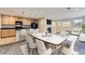 Open kitchen and dining area with stylish furnishings, fireplace, and modern appliances at 2032 Spruce St, Denver, CO 80238