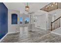 Spacious living area with decorative columns, gray flooring, and natural light from large windows at 3630 Sawgrass Trl, Castle Rock, CO 80109