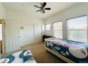 A bedroom is furnished with two twin beds, a ceiling fan, and a closet for storage at 18766 E Yale Cir # A, Aurora, CO 80013