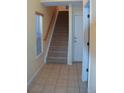 Bright entryway with tiled floors and a carpeted staircase at 18766 E Yale Cir # A, Aurora, CO 80013