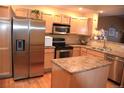 Modern kitchen featuring stainless steel appliances and an island at 18766 E Yale Cir # A, Aurora, CO 80013