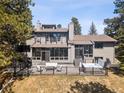 Spacious backyard deck features stylish patio furniture and a relaxing hot tub, perfect for outdoor living at 31607 Broadmoor Dr, Evergreen, CO 80439
