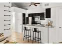 Modern kitchen featuring stainless steel appliances, black cabinetry, and a granite countertop with barstool seating at 11109 Alcott St # D, Westminster, CO 80234