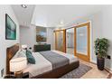 Bright bedroom with hardwood floors and access to a private balcony at 601 W 11Th Ave # 109, Denver, CO 80204