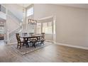 Bright dining room featuring wood floors, large windows, modern chandelier, and a staircase at 4763 Laurelglen Ln, Highlands Ranch, CO 80130