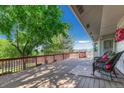 Relaxing back deck with comfortable seating and a scenic view of lush greenery at 1572 W Long Ave, Littleton, CO 80120