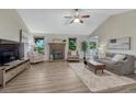 Inviting living room with a brick fireplace and lots of natural light at 1572 W Long Ave, Littleton, CO 80120