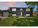 Charming two-story home with dark gray exterior and well-maintained front lawn at 18355 W 59Th Dr, Golden, CO 80403