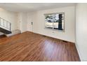 Spacious living room featuring hardwood floors, a large window, and ample natural light at 3552 S Kittredge St # C, Aurora, CO 80013