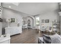 Elegant living and dining area with hardwood floors and white walls, flooded with natural light at 9683 Las Colinas Dr, Lone Tree, CO 80124