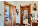 Hallway with dark, stained wood doors, shelving, and trim at 1650 N Pennsylvania St, Denver, CO 80203