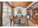 Bright dining room featuring a chandelier, large window, and adjacent butler's pantry at 2116 Ridgetrail Dr, Castle Rock, CO 80104