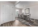 Light filled dining area features a dining table with seating for six and a large window at 350 Mesa Ave, Lochbuie, CO 80603