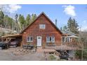 Charming wood home with a cozy front porch and landscaped front, perfect for outdoor gatherings at 356 Castlewood Dr, Evergreen, CO 80439
