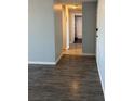 Hallway showing hardwood floors and bathroom with shower and tub at 2225 Buchtel Blvd # 207, Denver, CO 80210