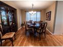 Elegant dining room with wood floors, traditional furniture, and a decorative chandelier at 8908 Jellison Ct, Westminster, CO 80021