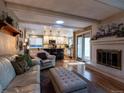 Open concept living space features hardwood floors, a fireplace, and seamless access to a modern kitchen at 8908 Jellison Ct, Westminster, CO 80021