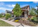 Charming home showcasing a beautiful exterior, inviting porch, and manicured landscaping at 10859 E 25Th Dr, Aurora, CO 80010