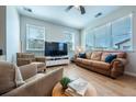 Bright living room featuring large windows, comfortable seating, modern entertainment center, and stylish decor at 4630 Copeland Cir # 201, Highlands Ranch, CO 80126