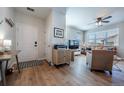 Open-concept living room showcasing stylish decor, wood-look floors, a ceiling fan, and a comfortable seating arrangement at 4630 Copeland Cir # 201, Highlands Ranch, CO 80126