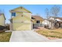 Charming yellow two-story home with an attached garage and landscaped front yard at 13463 Quivas St, Westminster, CO 80234