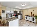 Well-lit kitchen featuring stainless steel appliances, granite countertops, and ample cabinet space at 2182 S Victor St # D, Aurora, CO 80014
